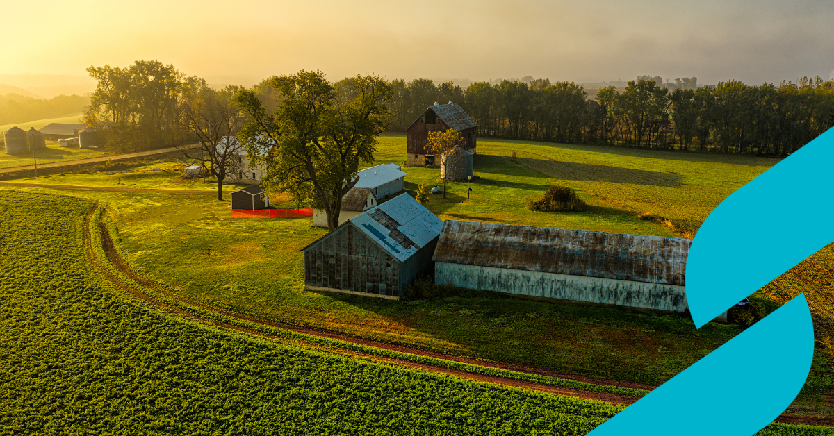 An ariel photo of multiple farm buildings and farm fields
