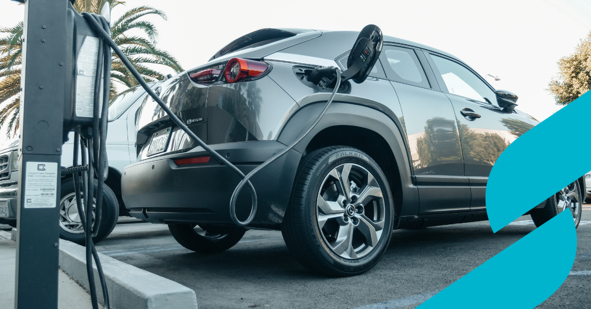 Electric car plugged into charging point